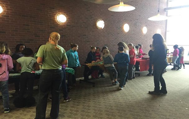  Farmers supervise the market activity with children running the market as farmers and shoppers. Photo credit: Dawn Nelson