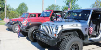 Picture of jeeps in a parade.