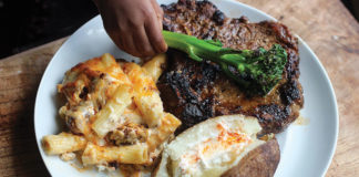 Steak, Baked Mac-n-Cheese, and Baked Potato with Brussels Sprout Garnish.