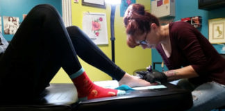 Jamie tattooing minor at Lovely Monkey