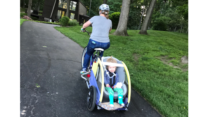 Courtney Stinson pulls Ellie in an adapted bike trailer.