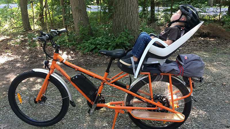 Oskar Adams asleep after a ride on his mom’s longtail cargo bike. 