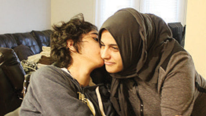 Hiatham Breadiy gives his mother, Azeza Kasham, a kiss. He has a rare form of epilepsy called Lafora. The disease typically strikes seemingly healthy children in their teens and progressively gets worse over time.