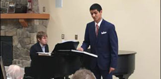 University of Michigan students Jeremy D'Silva (singing) and Bryce Messman (at the piano) perform for Glacier Hills residents earlier this year