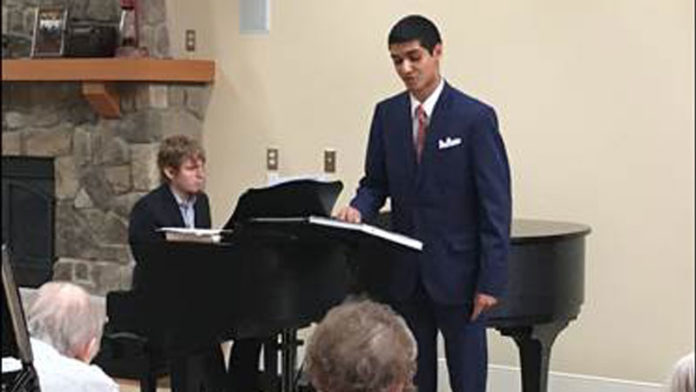 University of Michigan students Jeremy D'Silva (singing) and Bryce Messman (at the piano) perform for Glacier Hills residents earlier this year