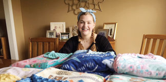 Emily McCulloch with some of the blankets that she will be delivering to recipients at local hospitals.