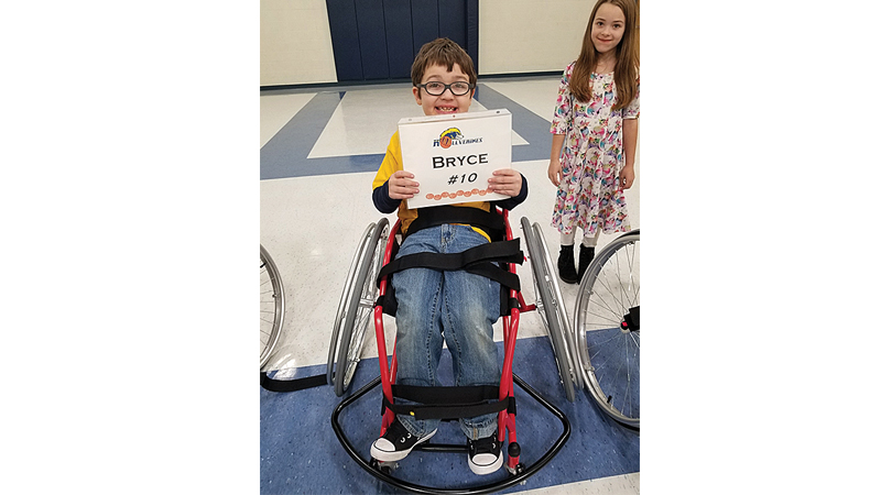 Bryce Hollis, 10, plays an adaptive form of basketball as part of the University of Michigan Adaptive and Inclusive Sports Experience. Photo contributed by Christina Hollis
