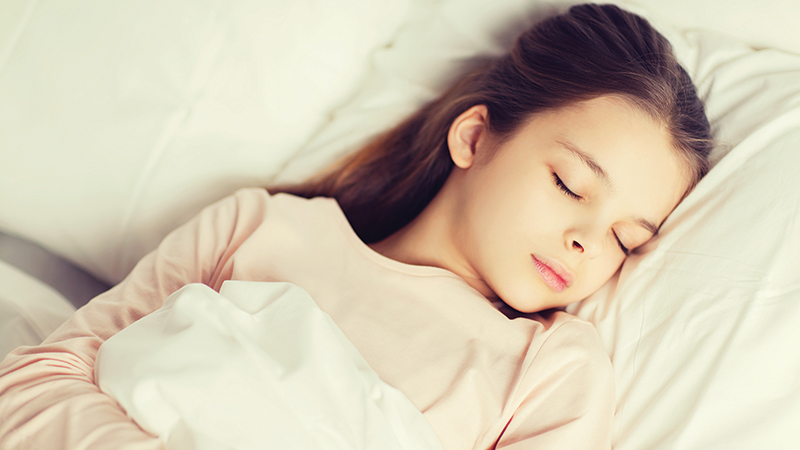 girl-sleeping-in-bed-at-home-PP4SY3S