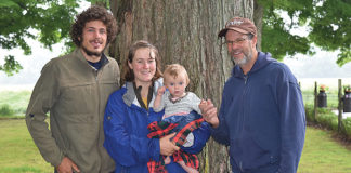 Three generations of Whitneys: Matthew and Malaika with baby Able, and grandpa John, on the farm. Photo by Dawn Nelson