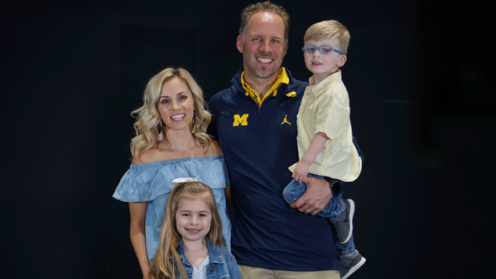 UM quarterbacks coach Ben McDaniels with his family: wife, Kyle; and children, Kinley Grace, 6; and Brooks Thomas, 3. While football looms large in the McDaniels household, the kids are busy just being kids. McDaniels said Kinley loves cheer, dance and gymnastics, while Brooks is into trucks, wrestling and pretending he has superpowers. Photo by Aaron Bills/Michigan Football.