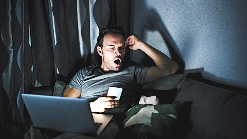 man-sitting-on-the-sofa-with-a-mobile-phone-and-6GLJK3S_150