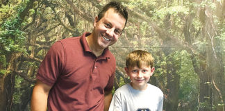 Dr. Mark Bowers and one of his patients, Connor, 9, pose in front of the forest wall at the Brighton Center for Pediatric Neurodevelopment. Photo contributed by Miranda Keskes.