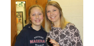 As a school administrator, educator and parent, Kim Jasper knows how distracting cell phones can be for students in school. Jasper, assistant principal at Milan Middle School, where her daughter, Cristin (L), attends, enforces a policy of no personal cell phones for students. Photo Credit: Lori Maranville.