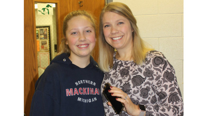 As a school administrator, educator and parent, Kim Jasper knows how distracting cell phones can be for students in school. Jasper, assistant principal at Milan Middle School, where her daughter, Cristin (L), attends, enforces a policy of no personal cell phones for students. Photo Credit: Lori Maranville.
