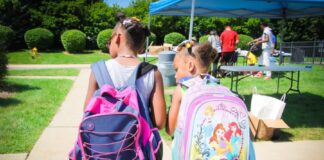 Two kids with backpacks on.