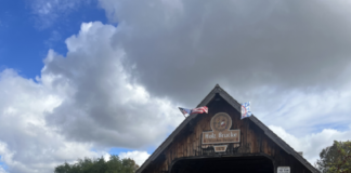 An older building or shelter by a bridge.