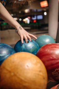 A photo of bowling balls at a bowling alley.