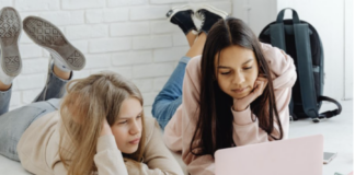 Two people looking at a laptop.