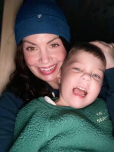 A parent and child taking a photo together.