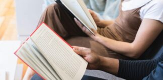 A photo of people reading a book.
