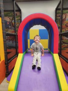 A child playing on a slide.