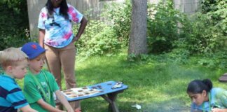 Kids working around a campfire.
