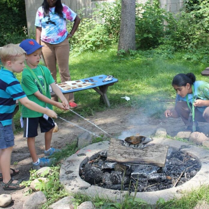 Kids working around a campfire.