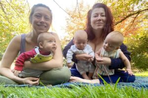Women and babies smiling