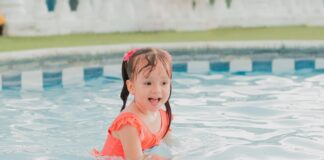 Young girl playing in swimming pool