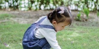 A child playing in the grass.
