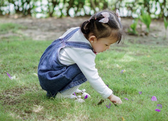 A child playing in the grass.