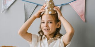 A photo of a child with a party hat on.