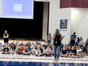 A principal speaking to students.