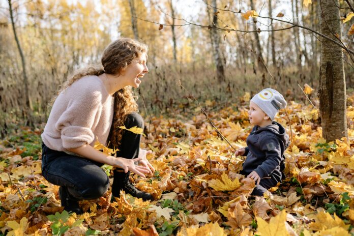 Woman and child in yellow leaves