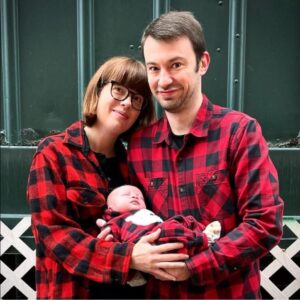 Man and woman with baby in matching pajamas