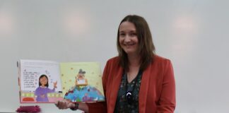 Woman holding up book while reading