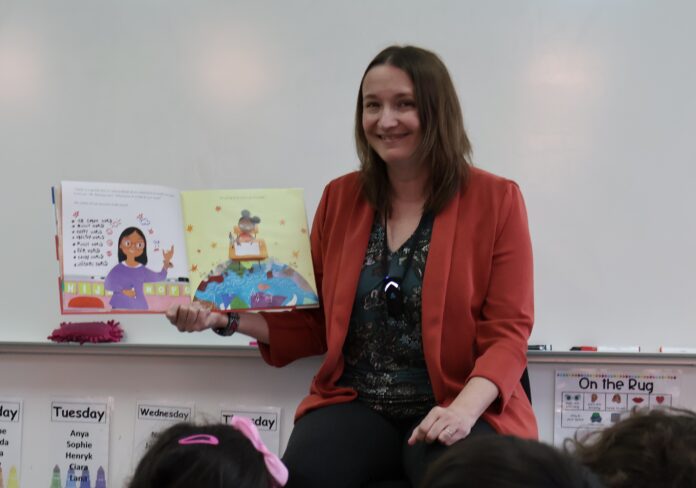 Woman holding up book while reading