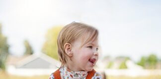 Little girl grabbing a pumpkin