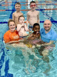Photo of instructors and kids in pool