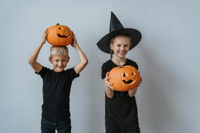 2 kids with pumpkins