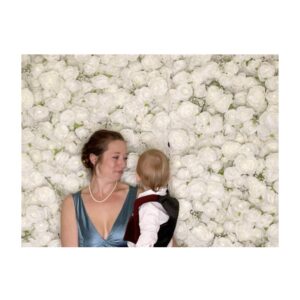 baby and woman against flower backdrop