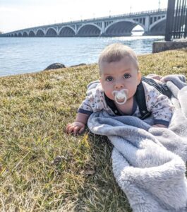 baby in front of bridge