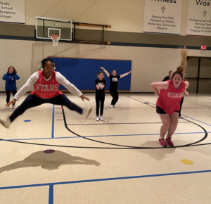 Cheerleaders jumping in gym
