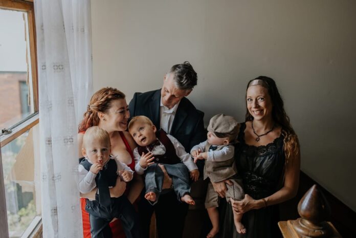 Three adults and three triplets posing for photo