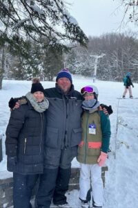 Photo of three people in the snow