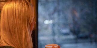 Women looking out window while rainy