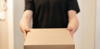 Person in black shirt handing over box