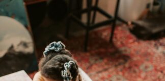 Two young girls coloring at table
