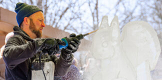 Man carving ice at ice festival