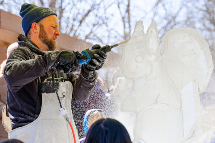 Man carving ice at ice festival